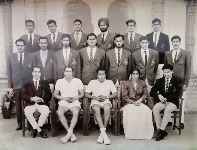 Poovma with her group at the camp, only woman in a group of men, sitting strong and determined.