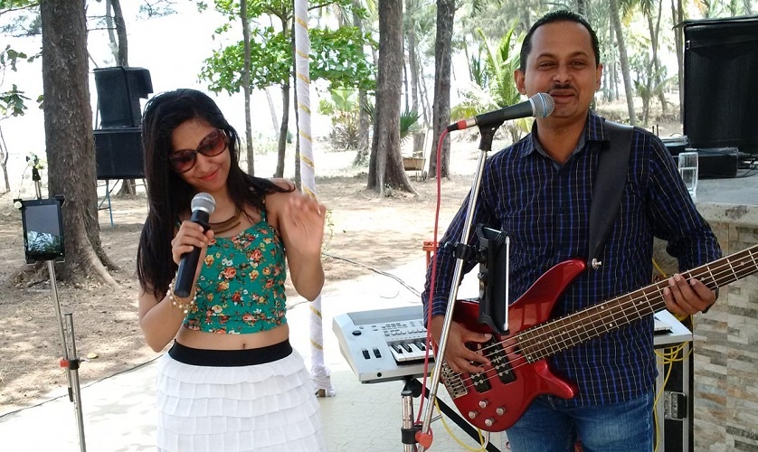 Small band of two, Lindsay sings along while playing the guitar and Reena sings incredibly