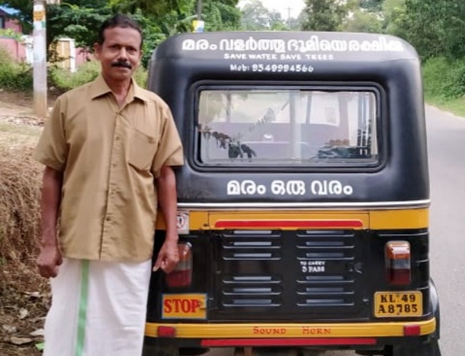 Shyam's auto has the slogan 'Save Water- Save Trees’ printed on its rear end