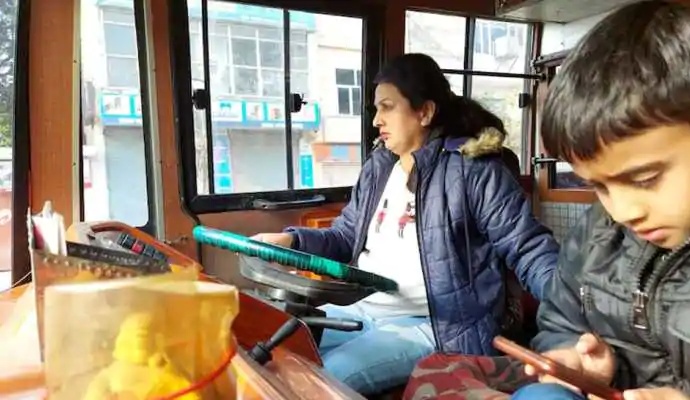 Pooja held the steering wheel of the passenger bus and drove passengers on the Jammu-Kathua road with her younger son innocently seated next to her