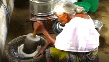 She then grinds coconuts, salt and adds other ingredients to them to prepare mouth-watering chutney in a traditional hand grinder